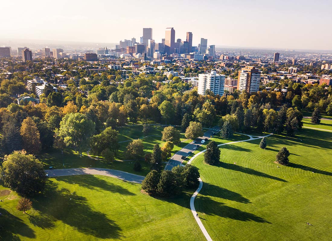 Insurance Solutions - Aerial View of a Park with Green Foliage in Denver Colorado with Views of Commercial Buildings and Downtown Skyscrapers in the Background
