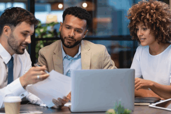 Is Your Business as Safe as You Think? A Comprehensive Guide to Liability Insurance - Three workers sitting at a table working together in front of a laptop